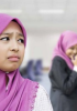 A young person in a hijab looking unhappy